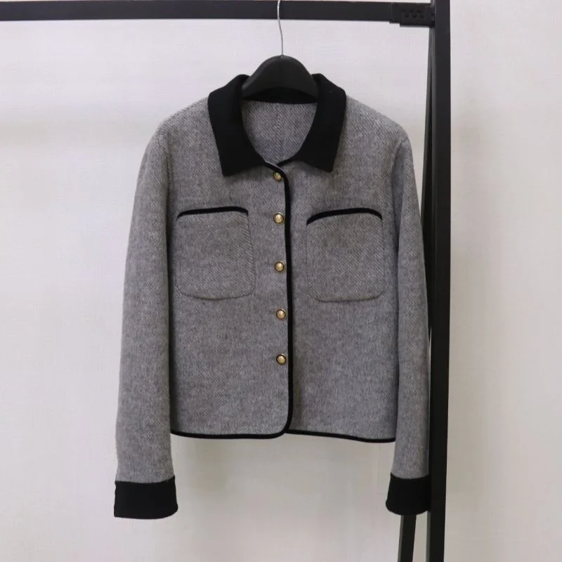 Contrast-Collar Wool-Blend Jacket — A short grey wool jacket with a black contrast collar and black bound edges, on a hanger