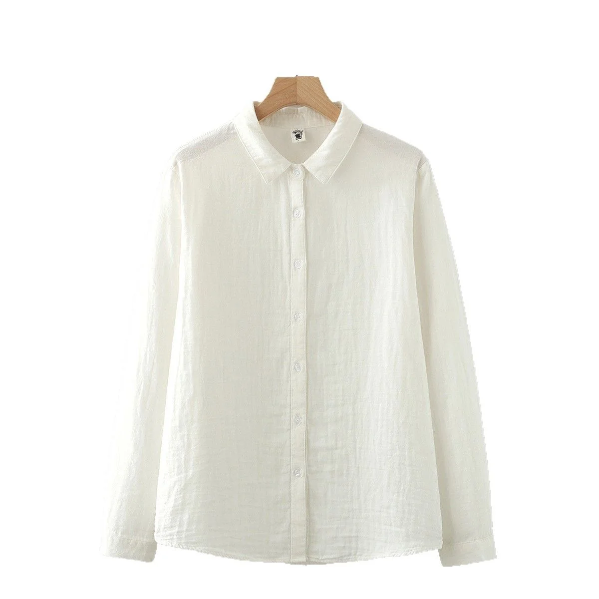 Double-Gauze Cotton Shirt — A white cotton double-gauze shirt with a pointed collar and small round buttons, hanging on a wooden hanger