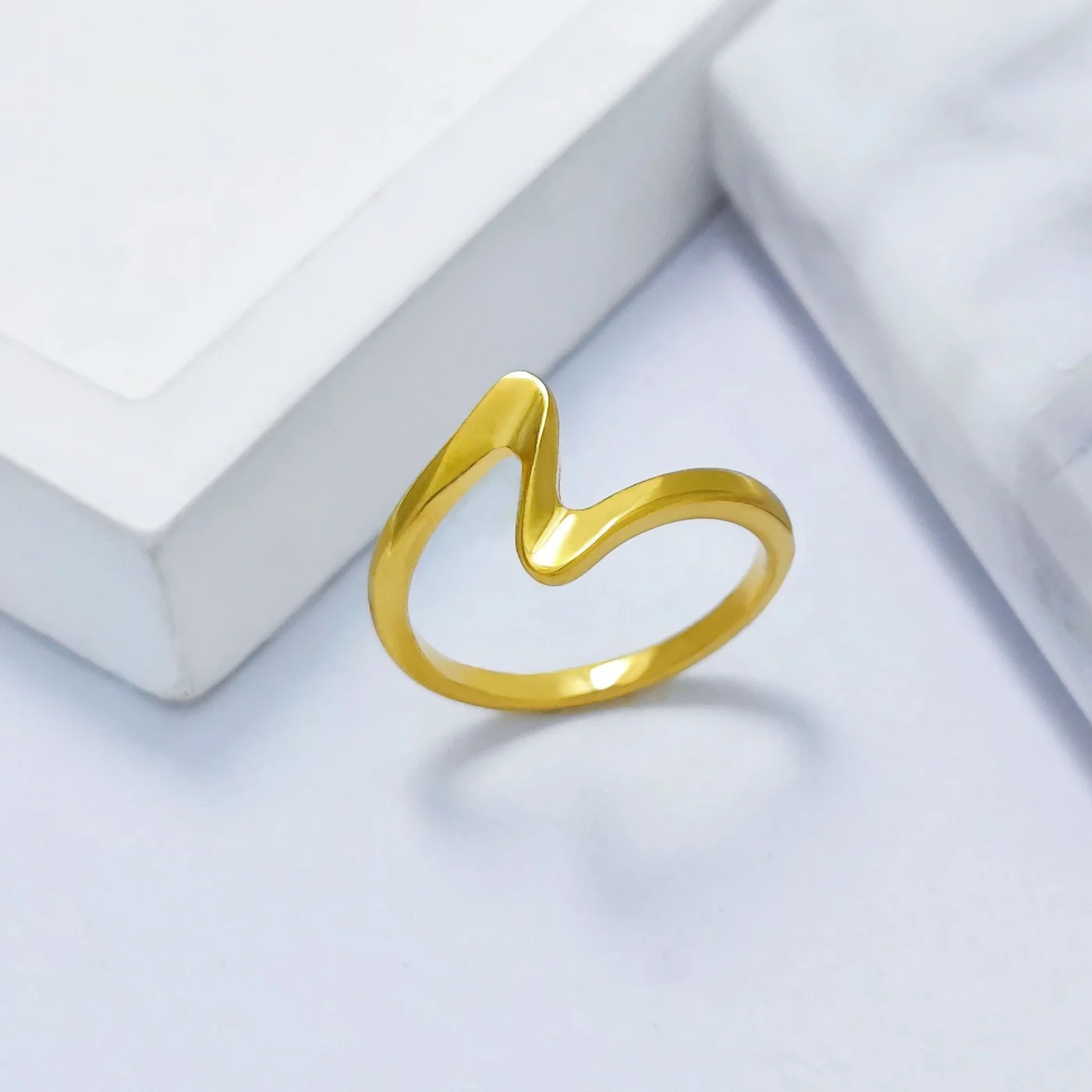 Gold Curve Ring — High-polish gold-tone stainless steel open ring with a soft curved peak