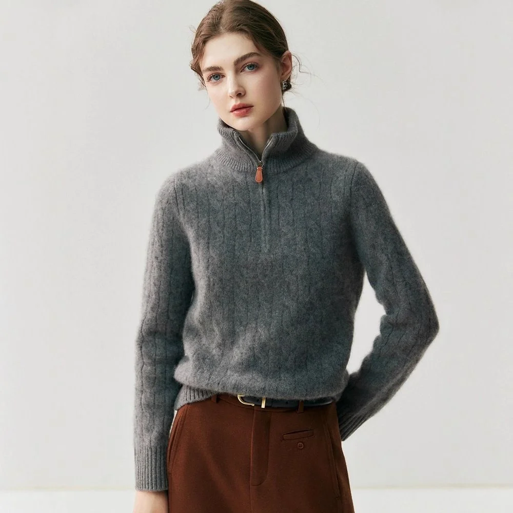 Half-Zip Cashmere Sweater — A thick brushed half-zip knit sweater worn by a model, shown in grey, cream, red and dark blue