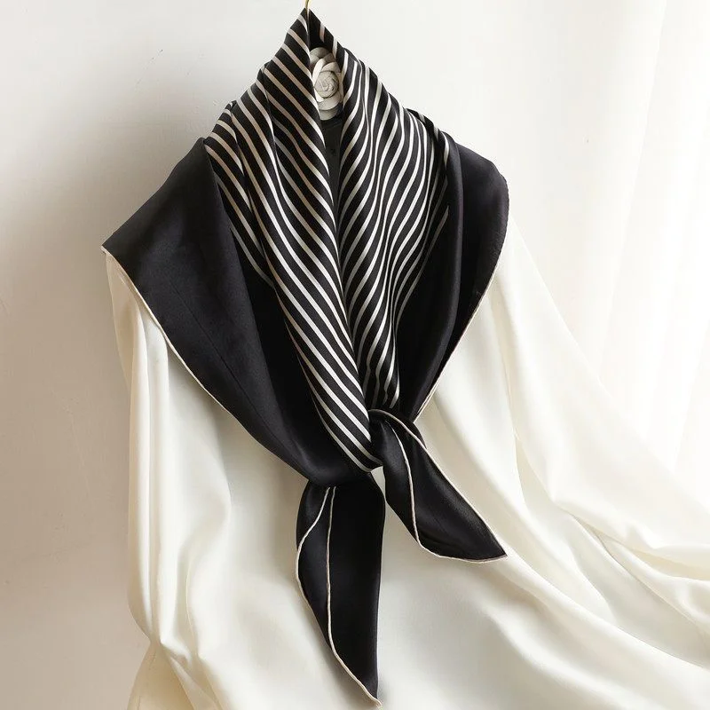 Striped Silk Square — A black and cream striped silk square, knotted over a hanger and tied at the neck